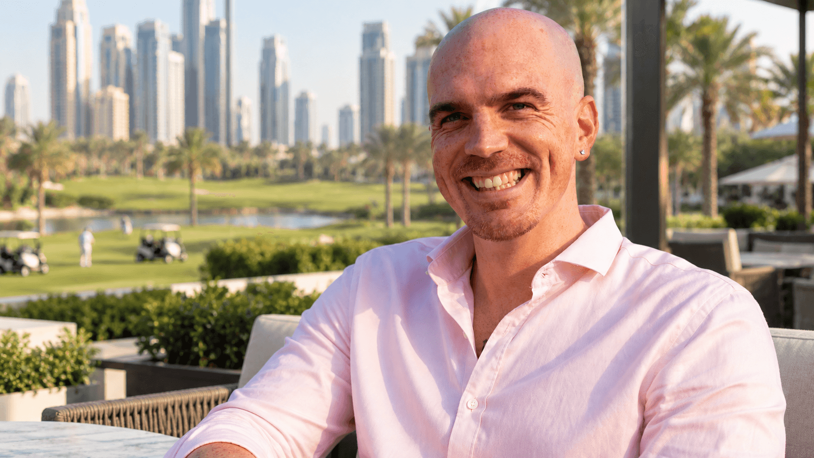 Alessandro Picchianti smiling on a terrace overlooking Downtown Dubai