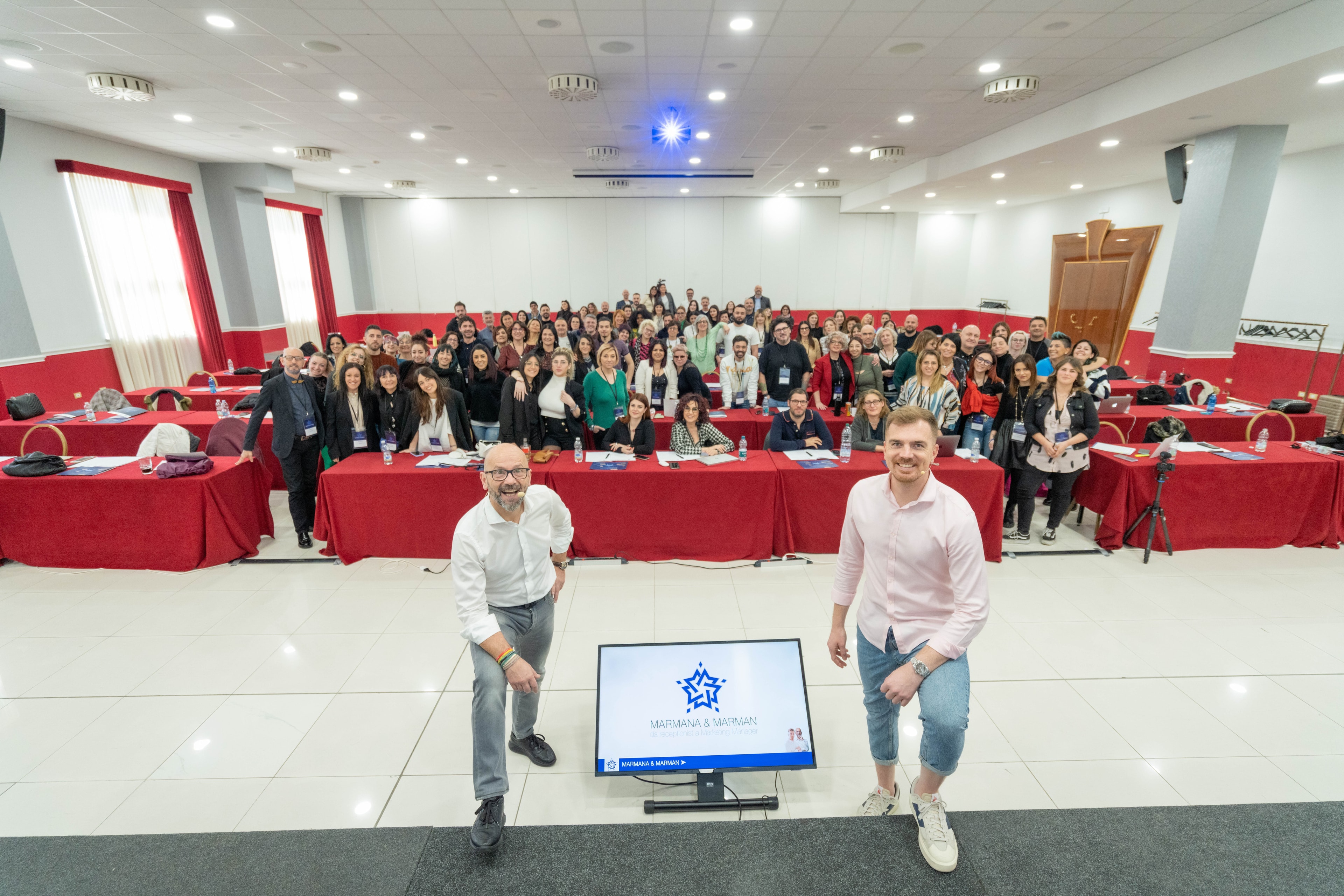 Alessandro Picchianti and his business partner in front of a full room of attendees
